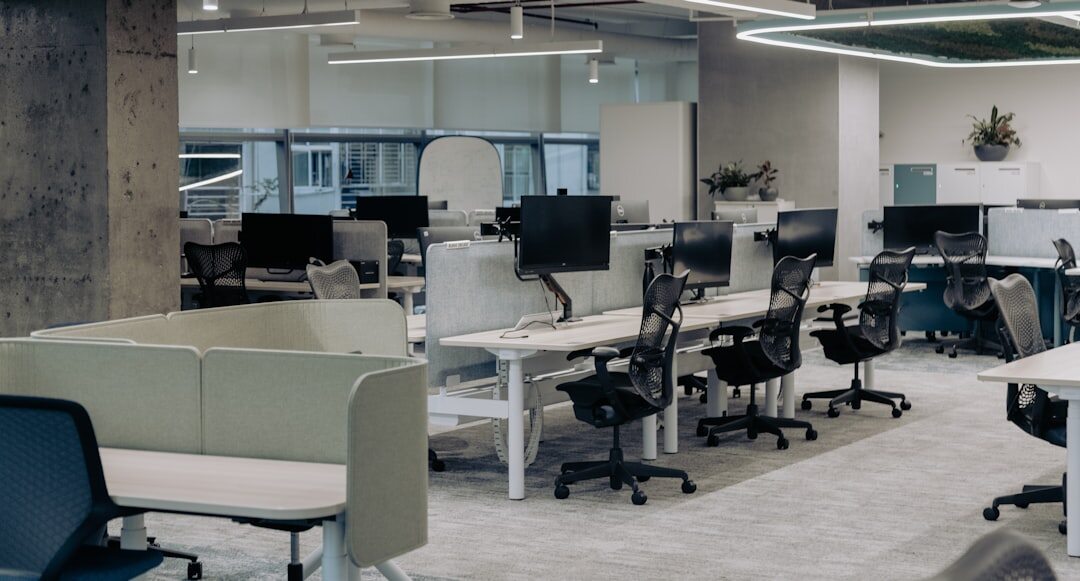 Modern newsroom office with laptops and desks