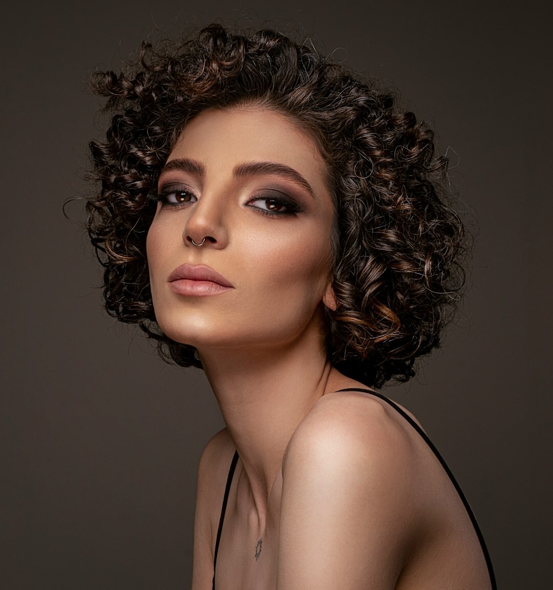 Studio portrait of a woman with curly hair
